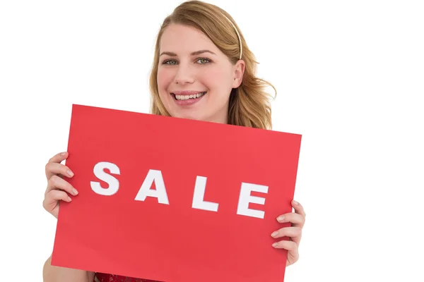 Cute blonde showing a red sale poster — Stock Photo, Image