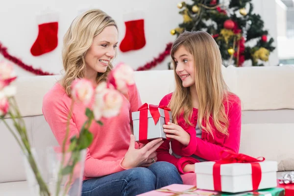 Festive mother and daughter with many gifts — Stock Photo, Image