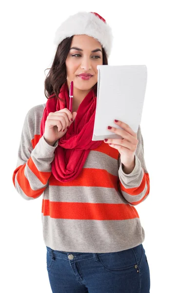 Festive brunette thinking about her christmas list — Stock Photo, Image