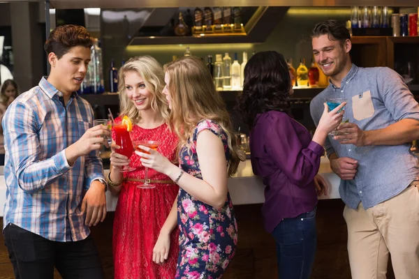 Happy friends having a drink together — Stock Photo, Image
