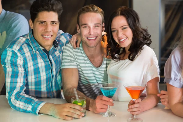 Young friends having a drink together — Stock Photo, Image