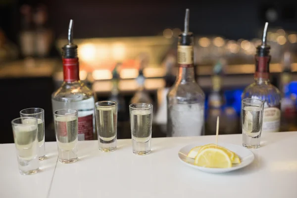 Tequila shots and lemon slices — Stock Photo, Image