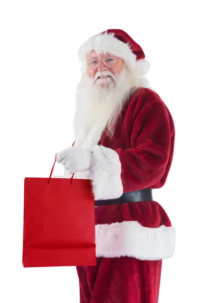 Santa draagt rode geschenk tas — Stockfoto