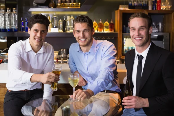 Handsome friends having a drink together — Stock Photo, Image