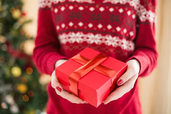 Close up of a woman offering a gift — Stock Photo, Image