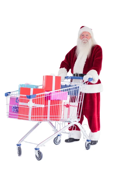 Santa empuja un carrito de compras mientras lee —  Fotos de Stock