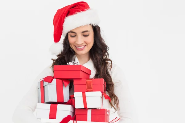 Festive brunette holding pile of gifts — Stock Photo, Image