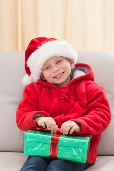 Feestelijke jongetje glimlachen op camera met cadeau — Stockfoto