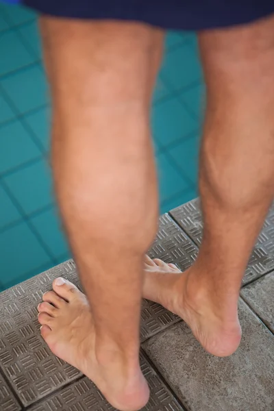 Swimmer standing by the pool — Stock Photo, Image