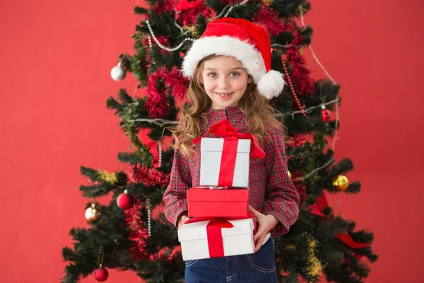 Festive little girl holding gifts — Stock Photo, Image