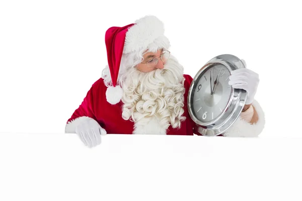 圣诞老人抱着一个时钟和标志 — 图库照片