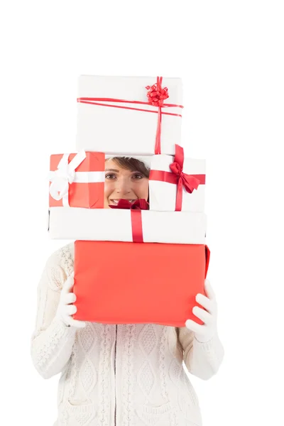 Festive young woman holding pile of gifts — Stock Photo, Image