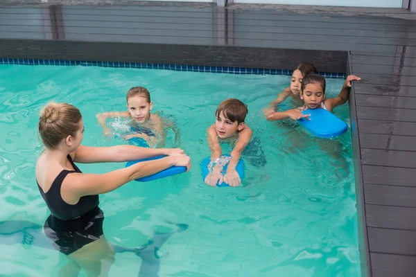 Aula de natação bonito na piscina com treinador — Fotografia de Stock