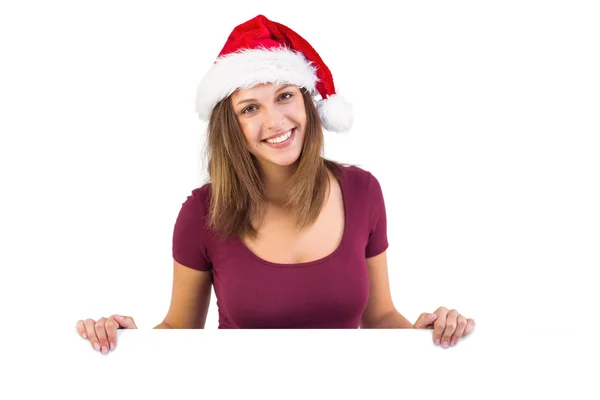 Festive brunette smiling at camera holding poster — Stock Photo, Image