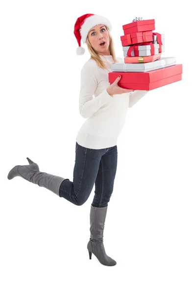 Festive blonde holding pile of gifts Stock Picture