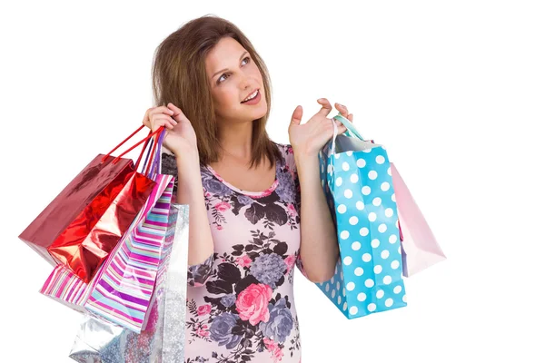 Thinking cute brunette holding shopping bags Stock Image