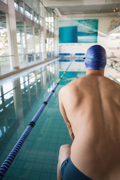 Rear view of shirtless swimmer by pool at leisure center — Stock Photo, Image