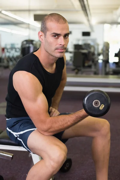 Man exercising with dumbbell in gym — Stock Photo, Image