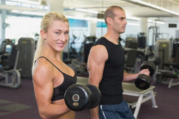 Paar trainiert mit Kurzhanteln im Fitnessstudio — Stockfoto