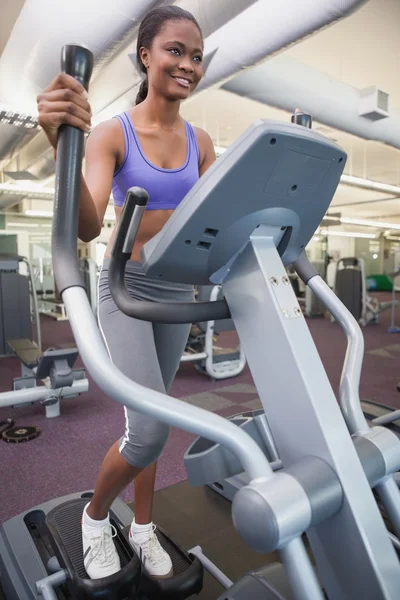 Fit woman working out on the cross trainer — Stock Photo, Image