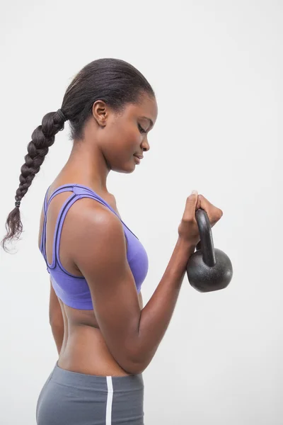 Fit woman lifting up kettlebell — Stock Photo, Image