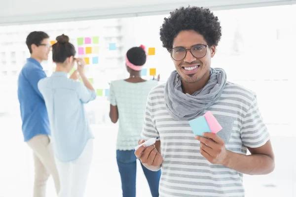 Young creative man smiling at camera — Stock Photo, Image