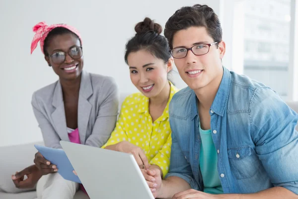 Young creative team working on couch — Stock Photo, Image