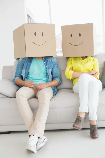 Young creative team wearing boxes on head — Stock Photo, Image