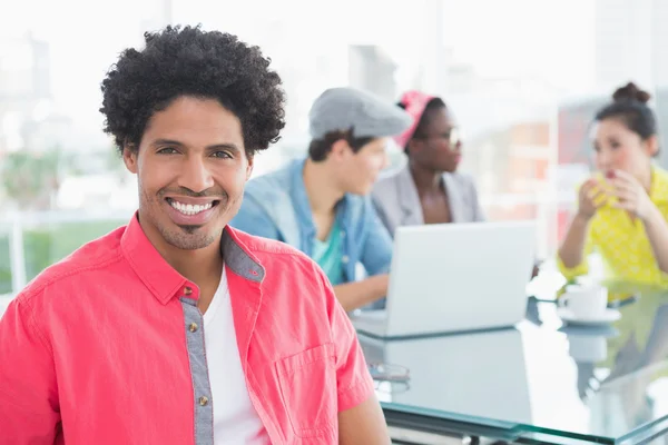 Young creative man smiling at camera — Stock Photo, Image