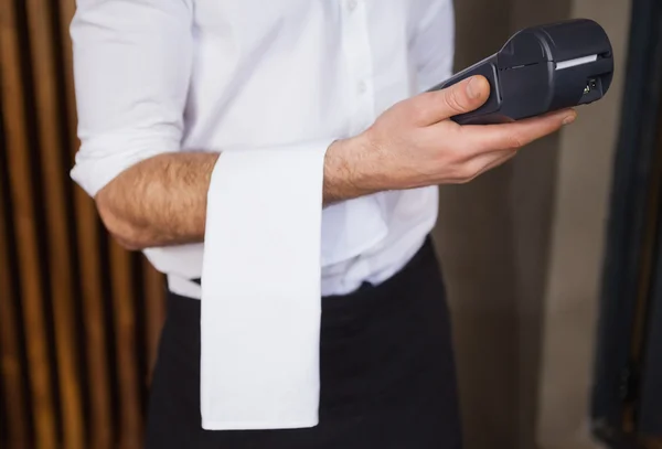 Handsome waiter holding credit card machine — Stock Photo, Image