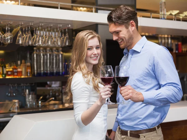 Encantador casal desfrutando de vinho tinto — Fotografia de Stock