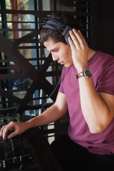 Cool dj working on a sound mixing desk — Stock Photo, Image