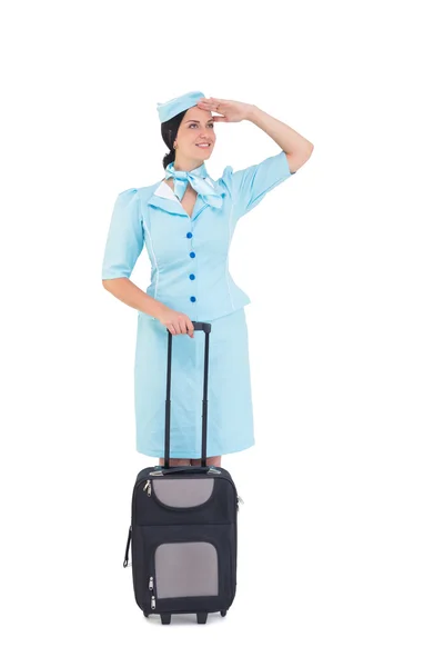 Pretty air hostess holding suitcase — Stock Photo, Image