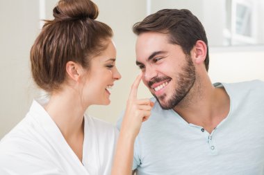 Young woman touching her boyfriends nose clipart