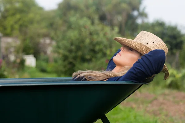 Pretty blonde napping in wheelbarrow — Stock Photo, Image