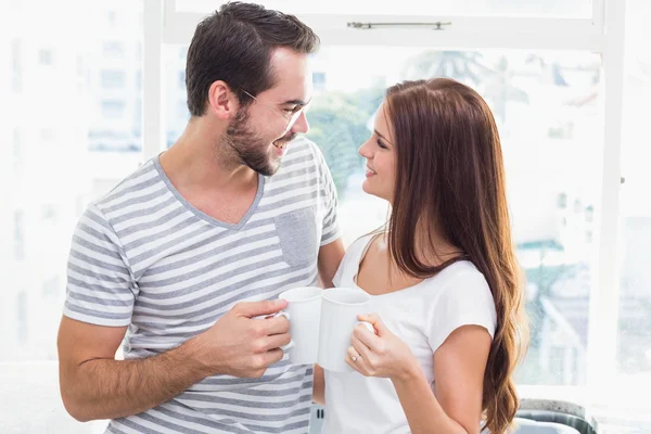 Young couple toasting their coffees — Stock Photo, Image