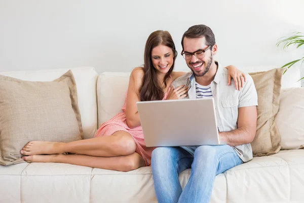 Couple Hipster en utilisant un ordinateur portable sur le canapé — Photo