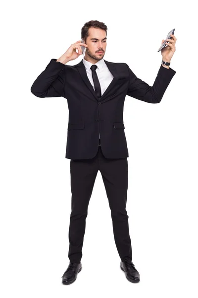 Businessman on the phone holding calculator — Stock Photo, Image