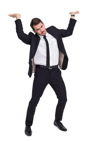 Uomo d'affari in giacca e cravatta che solleva qualcosa di pesante — Foto Stock