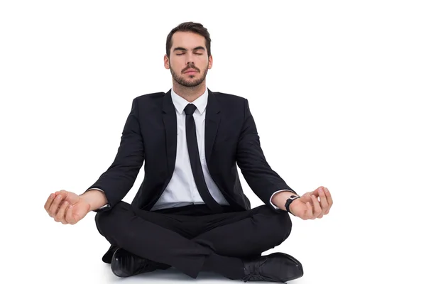 Peaceful businessman sitting in lotus pose relaxing — Stock Photo, Image