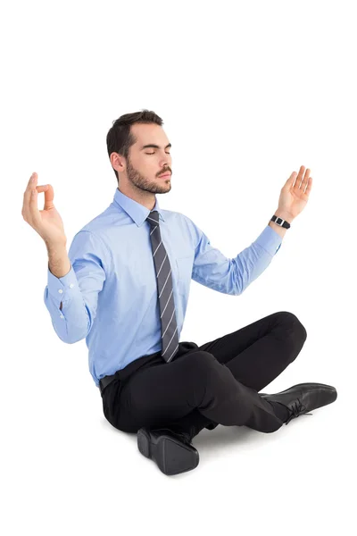 Relaxed businessman sitting in lotus pose — Stock Photo, Image