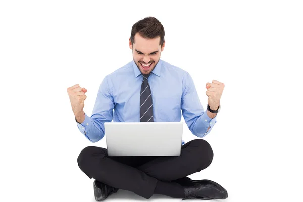 Businessman sitting with his laptop cheering — Stock Photo, Image