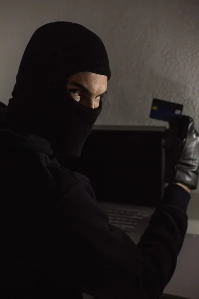 Hacker met behulp van debetkaart en laptop — Stockfoto