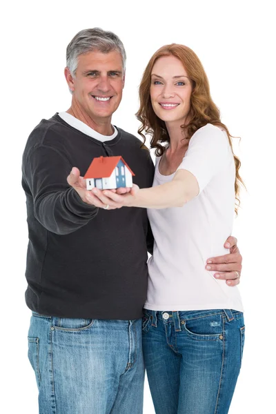 Casual couple holding small house — Stock Photo, Image