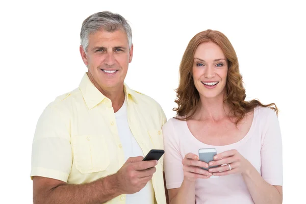 Casual couple sending text messages — Stock Photo, Image