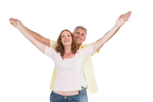 Casual couple smiling with arms raised — Stock Photo, Image