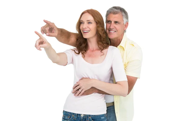 Casual couple smiling and pointing — Stock Photo, Image