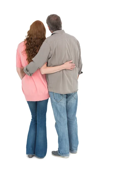 Casual couple standing arms around — Stock Photo, Image