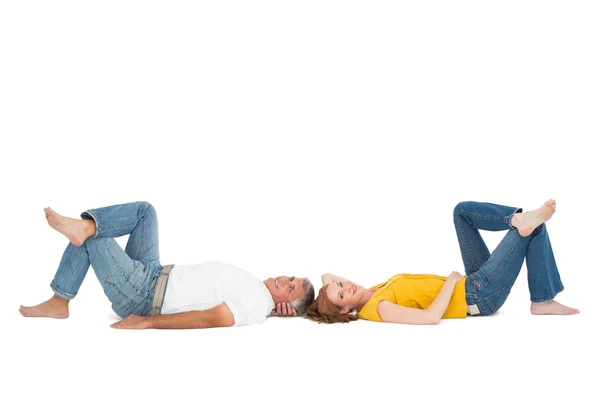 Casual couple lying on floor — Stock Photo, Image