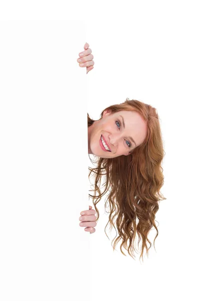 Pretty redhead showing a poster — Stock Photo, Image